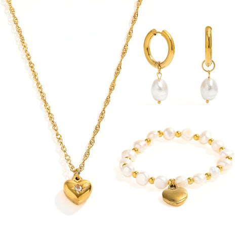 Le Grá Bundle - A captivating ensemble of love and elegance. Includes a Heart Pendant Necklace, a Dangling Heart Bracelet, a timeless Pearl Bracelet, and Gold Hoop Earrings with a delicate drop pearl. Each piece radiates sophistication, making this bundle a perfect expression of enduring love and classic beauty.