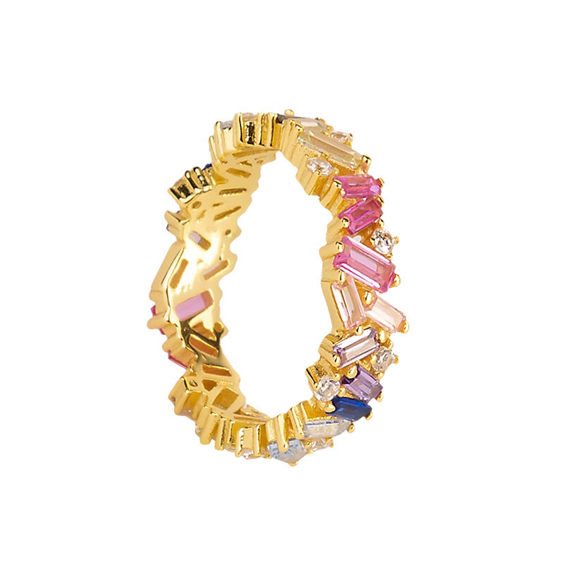 Multicoloured adorn ring from an Irish jewellery brand. The adorn ring is a colourful piece of jewellery. The sterling silver band is surrounded and covered in multicoloured zirconia stones which are set in unique and random ways. 