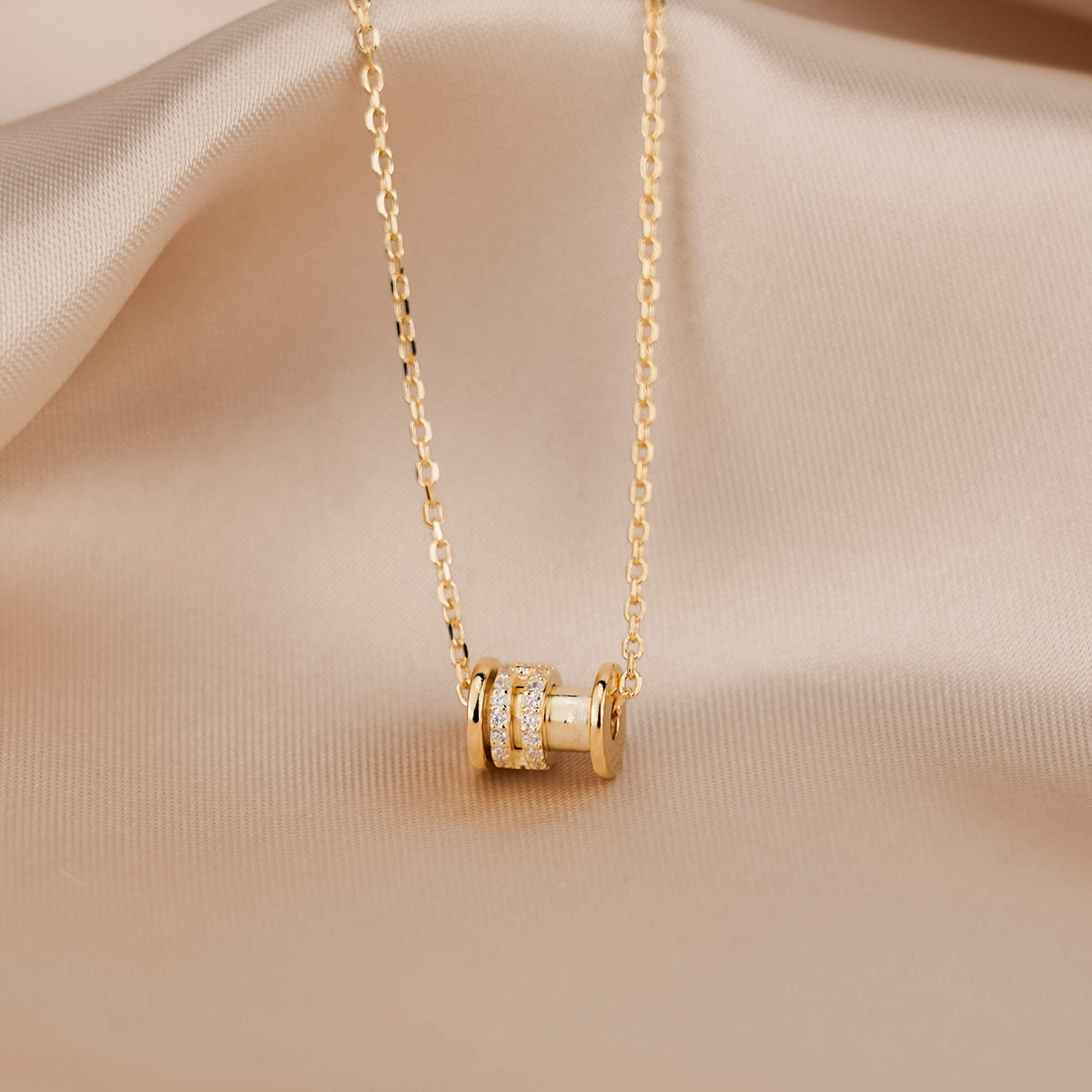 the astral necklace is a gold plated necklace with a dainty and elegant barrel pendant attached to a dainty gold chain. 