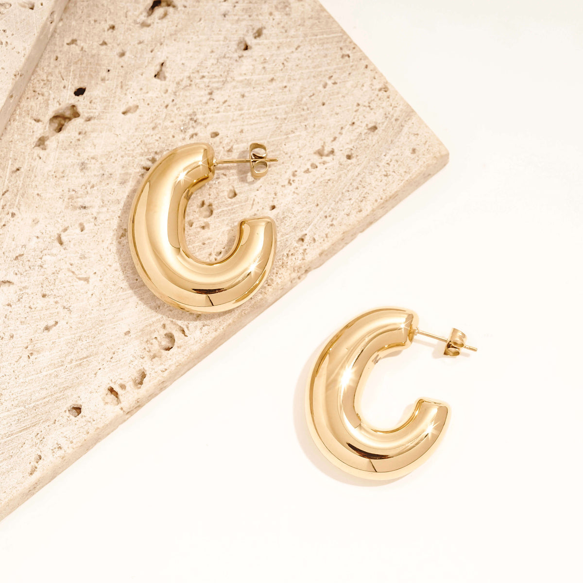 large, chunky hoop earrings that are statement hoops. they have a bubble or balloon like appearance. 