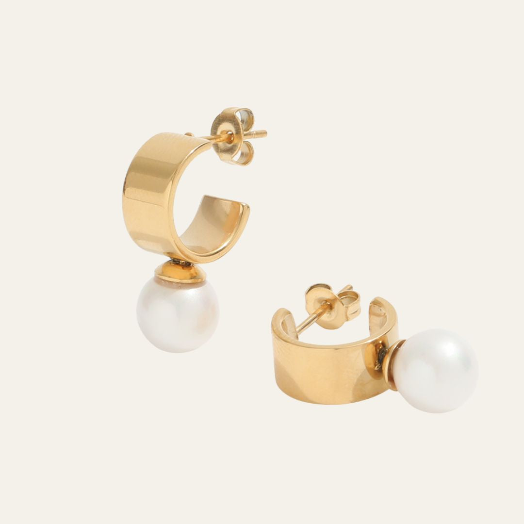 pearl earrings with a chunky gold band and the pearl fixed to the base of the hoop. These hoops are elegant and timeless and perfect wedding day accessories. 