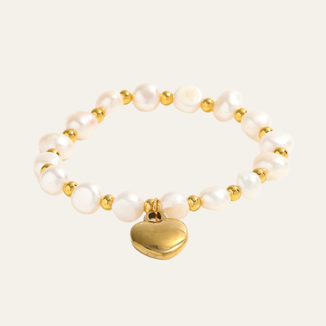 Dangling Heart Bracelet: A charming bracelet with a gold chain and a heart charm, a symbol of timeless affection