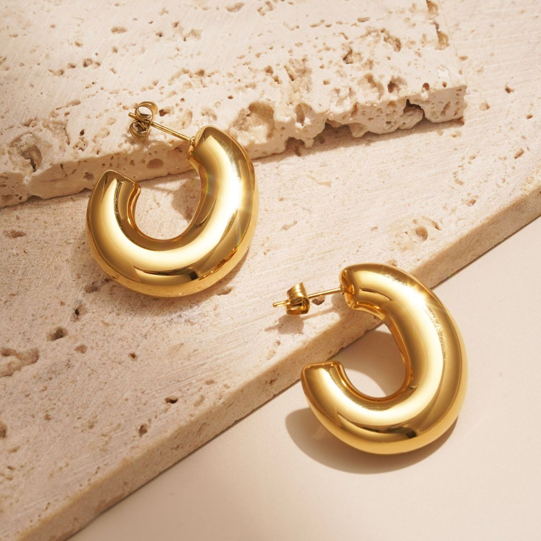 large, chunky hoop earrings that are statement hoops. they have a bubble or balloon like appearance.