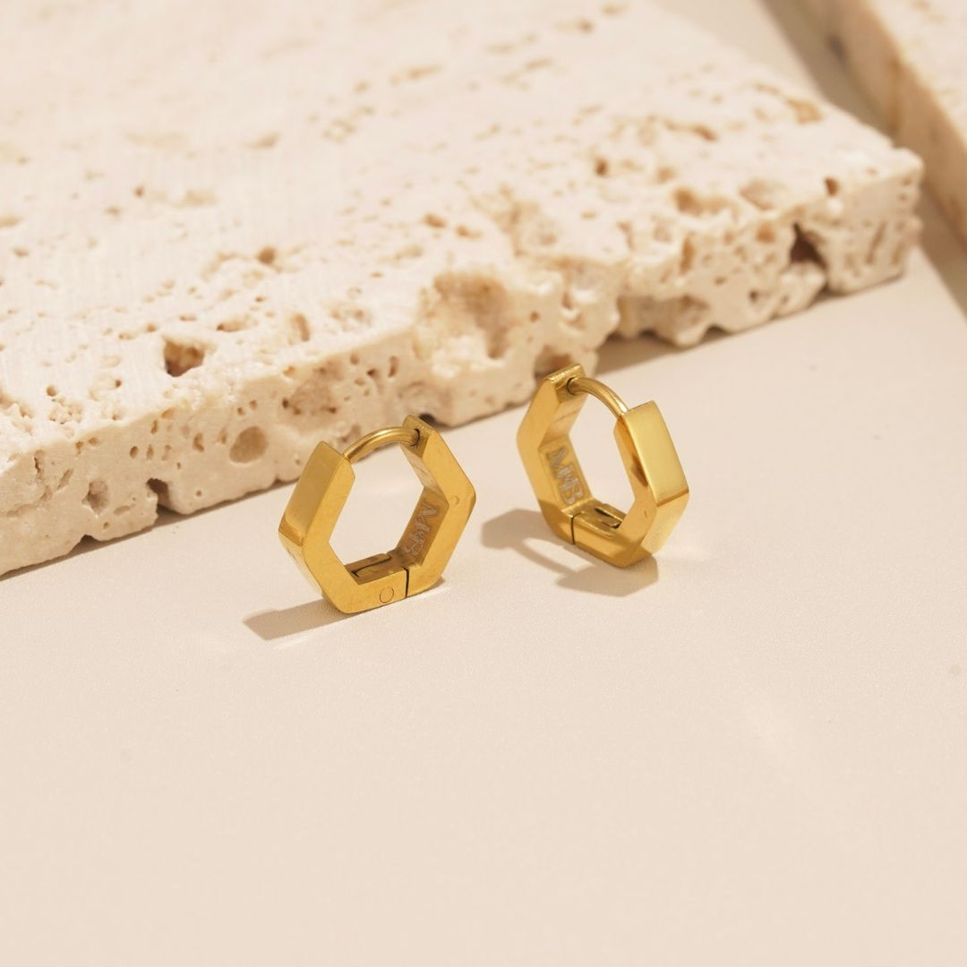 angular huggie hoop earrings that are comfortable to wear. The retro huggie hoops, also called sleepers, hug the earlobe closely. They are beautifully styled with the urbane hoop earrings. 