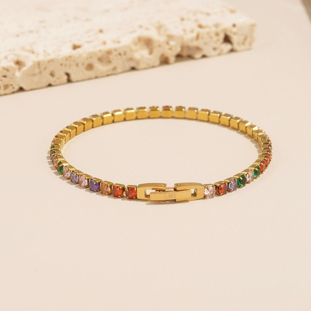 the colourful stellar bracelet is a multicoloured tennis bracelet that is bright, fun and vibrant. It features green, lilac, red and pink colours in abundance and it has a unique clasp. This tennis bracelet is perfect for someone with a unique but timeless style.