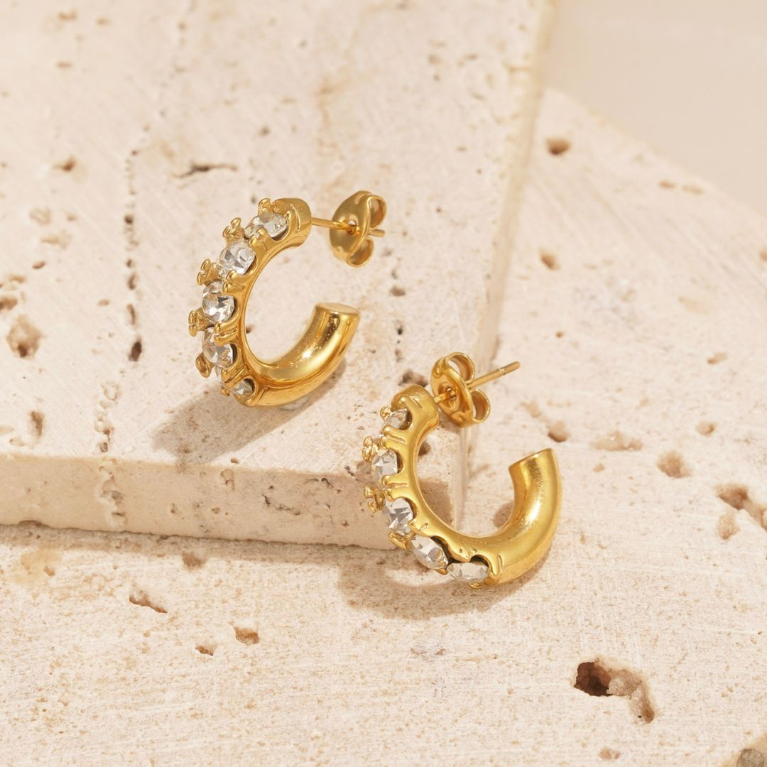 gold earrings with clear zirconia stones. the perfect size earrings for everyday wear.