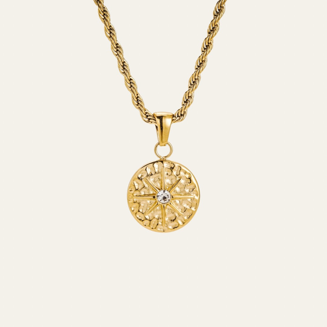 graduation gift. Designed to mirror the points of a compass, the Intuition Necklace is a quiet reminder that while maps can guide you, true direction often comes from within. Staying true to Mettle and Bloom's signature style, it is set on a softly hammered round pendant. The raised star motif draws the eye with its refined shape and the radiant centre stone captures the gaze.