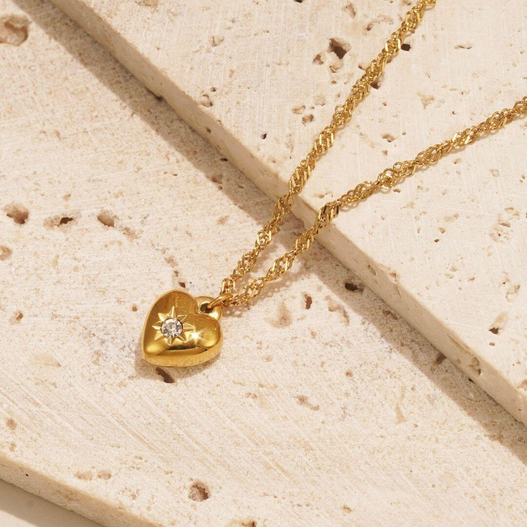 Indulge in the enchanting allure of the "Le Grá Necklace," a dainty piece that effortlessly combines elegance with a touch of celestial charm. The star-embellished heart pendant serves as the focal point, radiating a sense of love and cosmic beauty. 