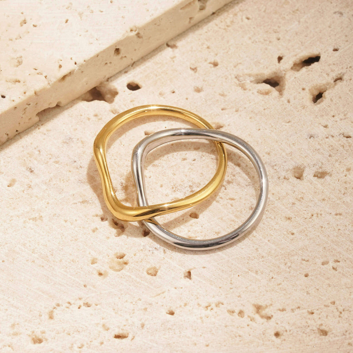 TWO TONE METAL JEWELLERY. this two tone ring has a gold band and a silver band, both of which are attached. they weave together to create a unique design. 