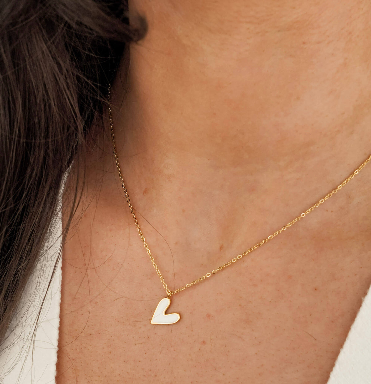 Valentine's gift idea for her - the Must be love necklace is a symbol of love. it has a white heart shaped pendant. 