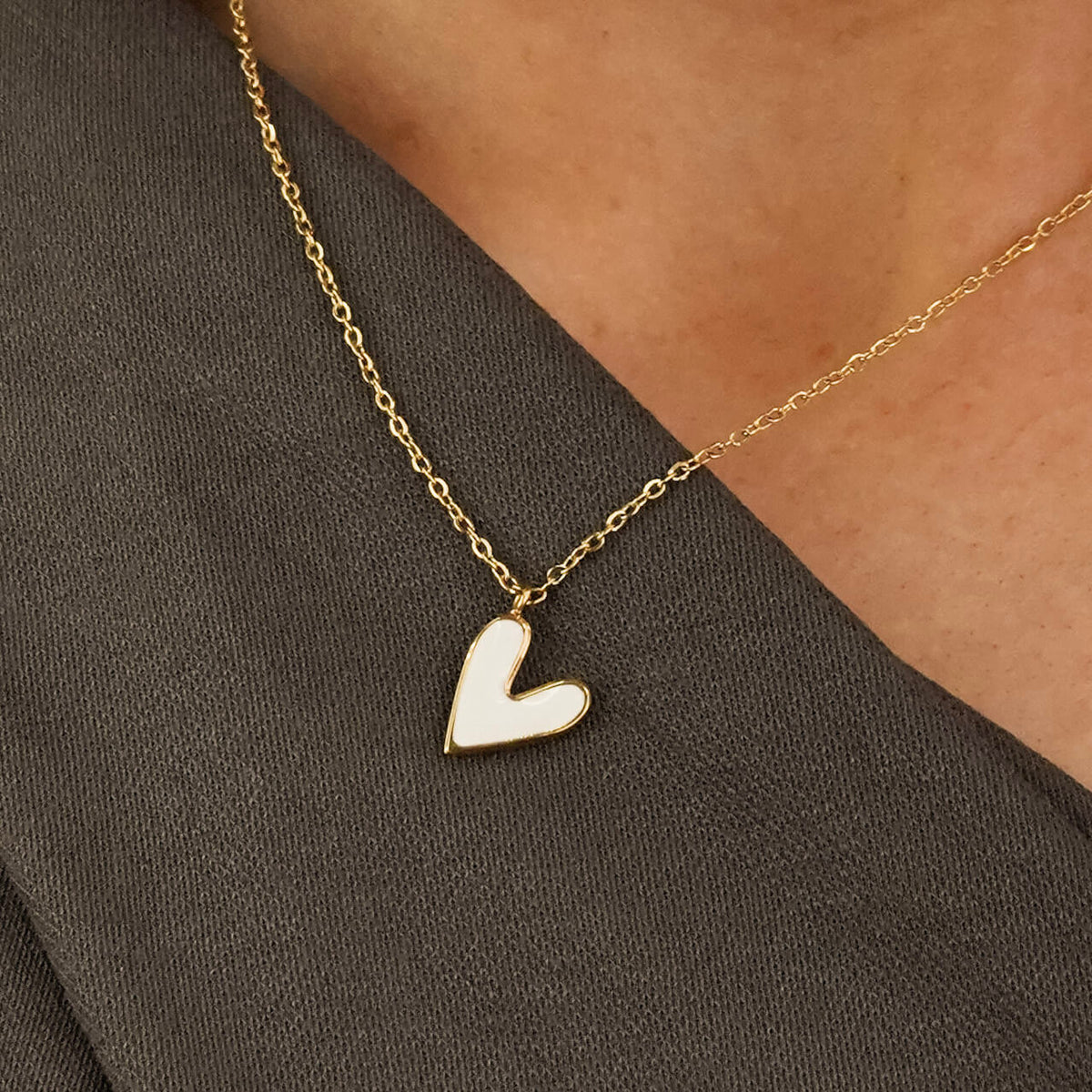 Valentine's gift idea for her - the Must be love necklace is a symbol of love. it has a white heart shaped pendant. 