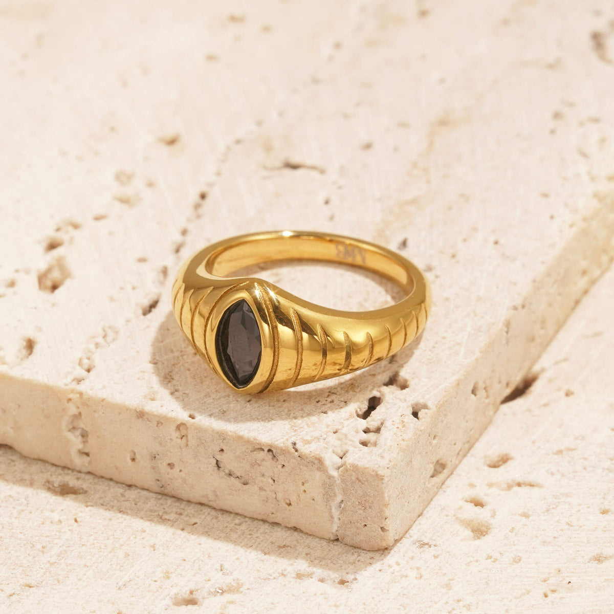 gold ring with black onyx stone which resembles a snakes eye.