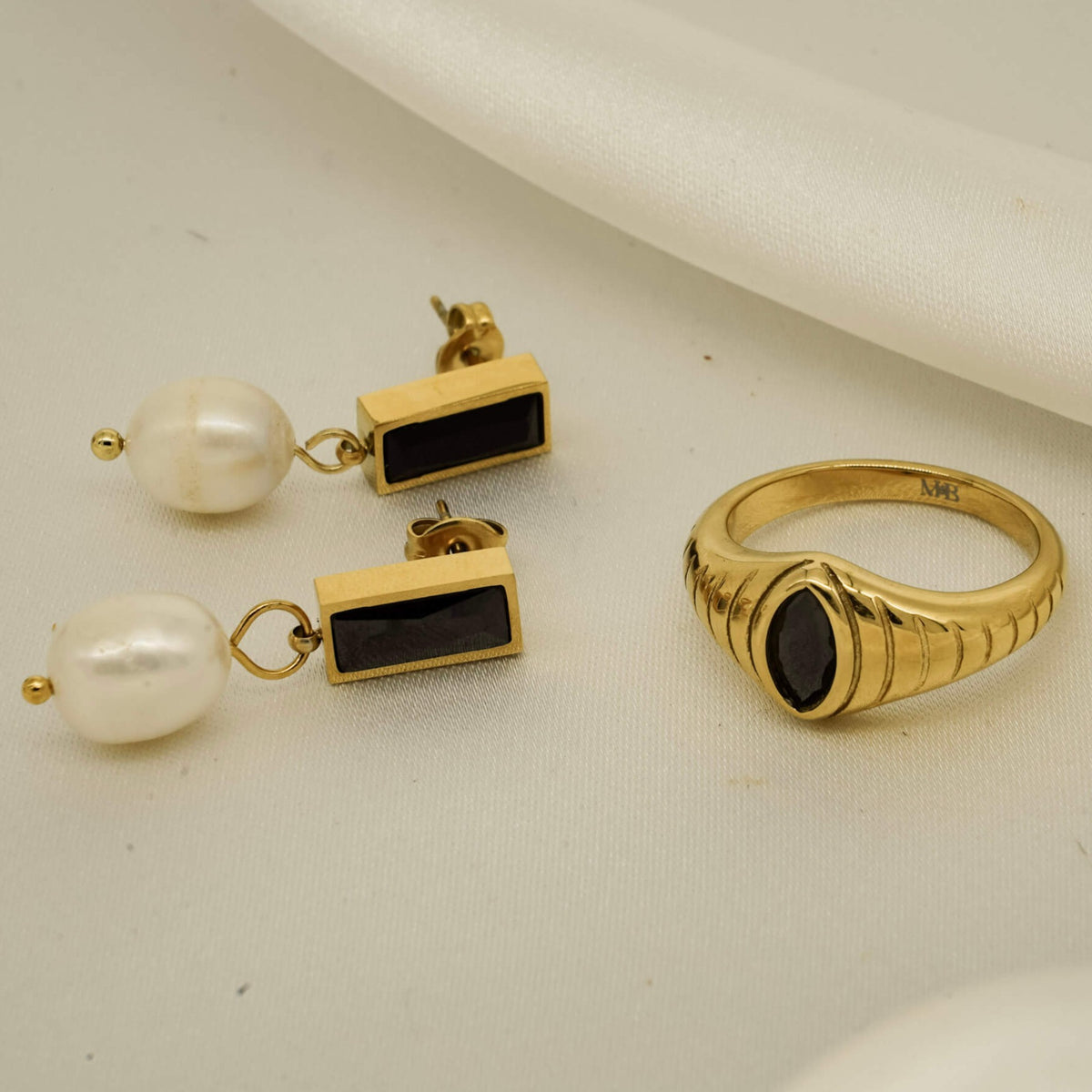 gold ring with black onyx stone which resembles a snakes eye. 