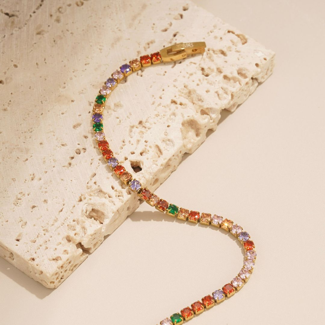 the colourful stellar bracelet is a multicoloured tennis bracelet that is bright, fun and vibrant. It features green, lilac, red and pink colours in abundance and it has a unique clasp. This tennis bracelet is perfect for someone with a unique but timeless style. 