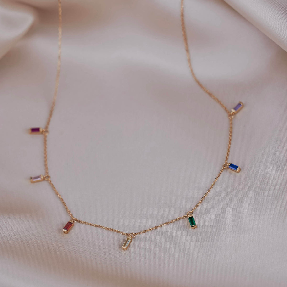 Chakra necklaces are beneficial for physical, mental, and spiritual well-being. They help balance the imbalanced chakras and help to open blocked chakras. This chakra necklace is colourful and photographed on silk.