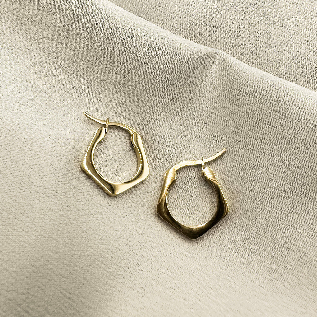 best selling earrings from Mettle & Bloom. These urbane hoop earrings have an angled design that is both contemporary and timeless. They have a hinge clasp and they are lightweight. 