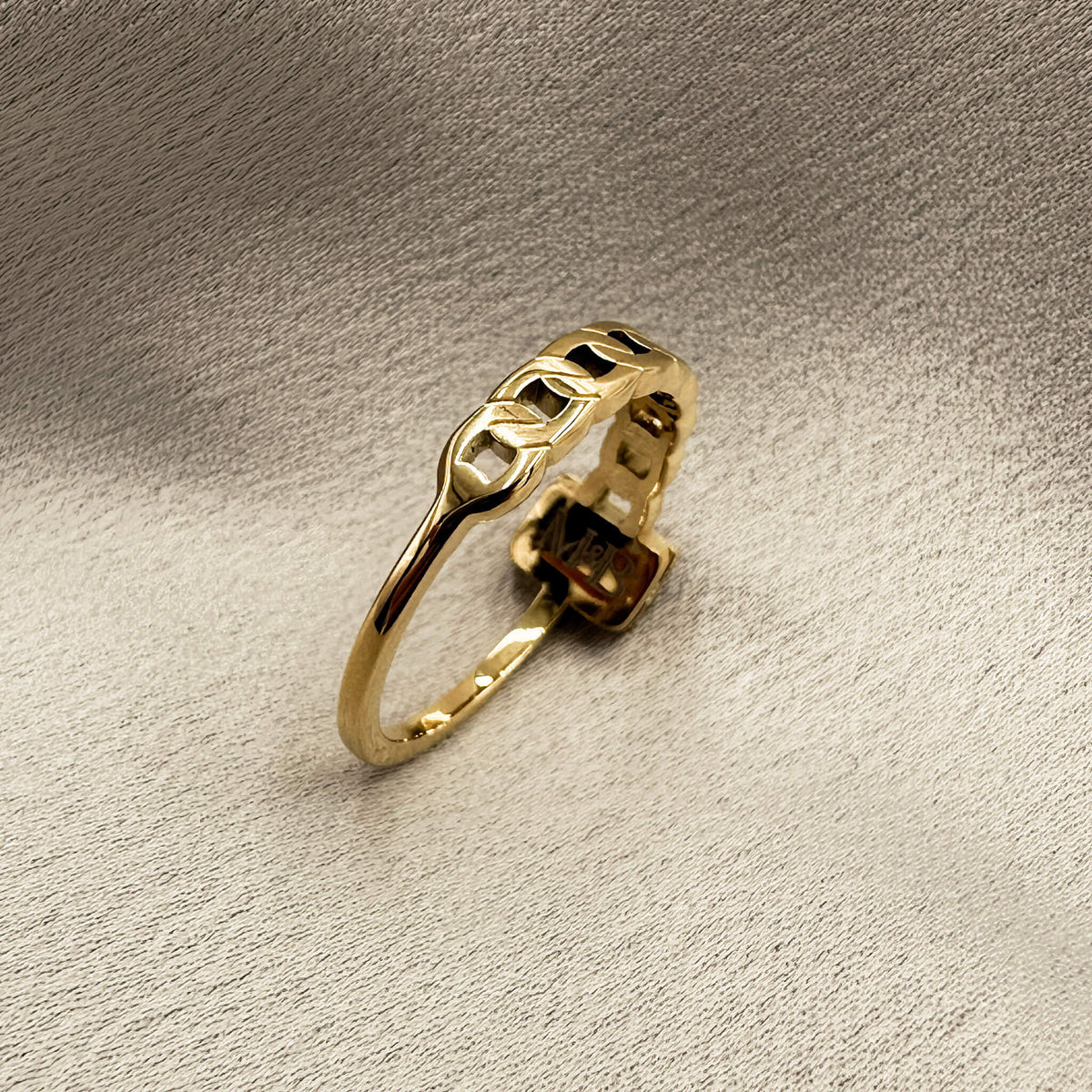 really unique gold ring with a black stud and a textured band on one size and a smooth and traditional band on the other. 